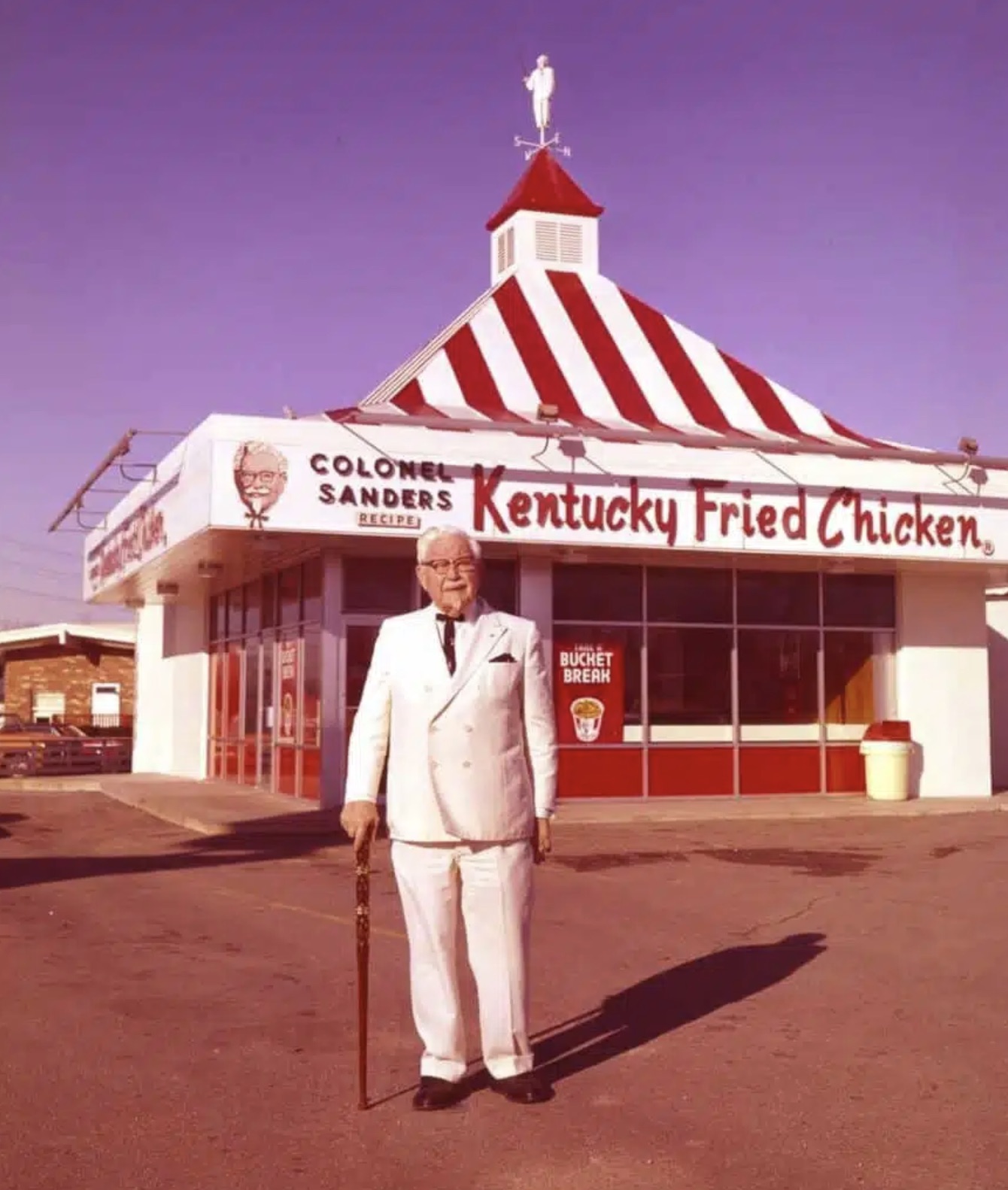 Colonel Sanders in front of the first Kentucky Fried Chicken restaurant 